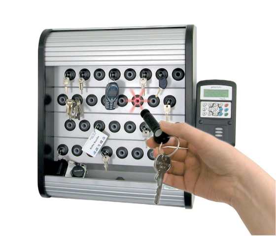 Close-up of keys hanging on hooks with one key slot highlighted in red