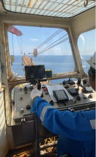Crane operator Husni working inside the crane cabin